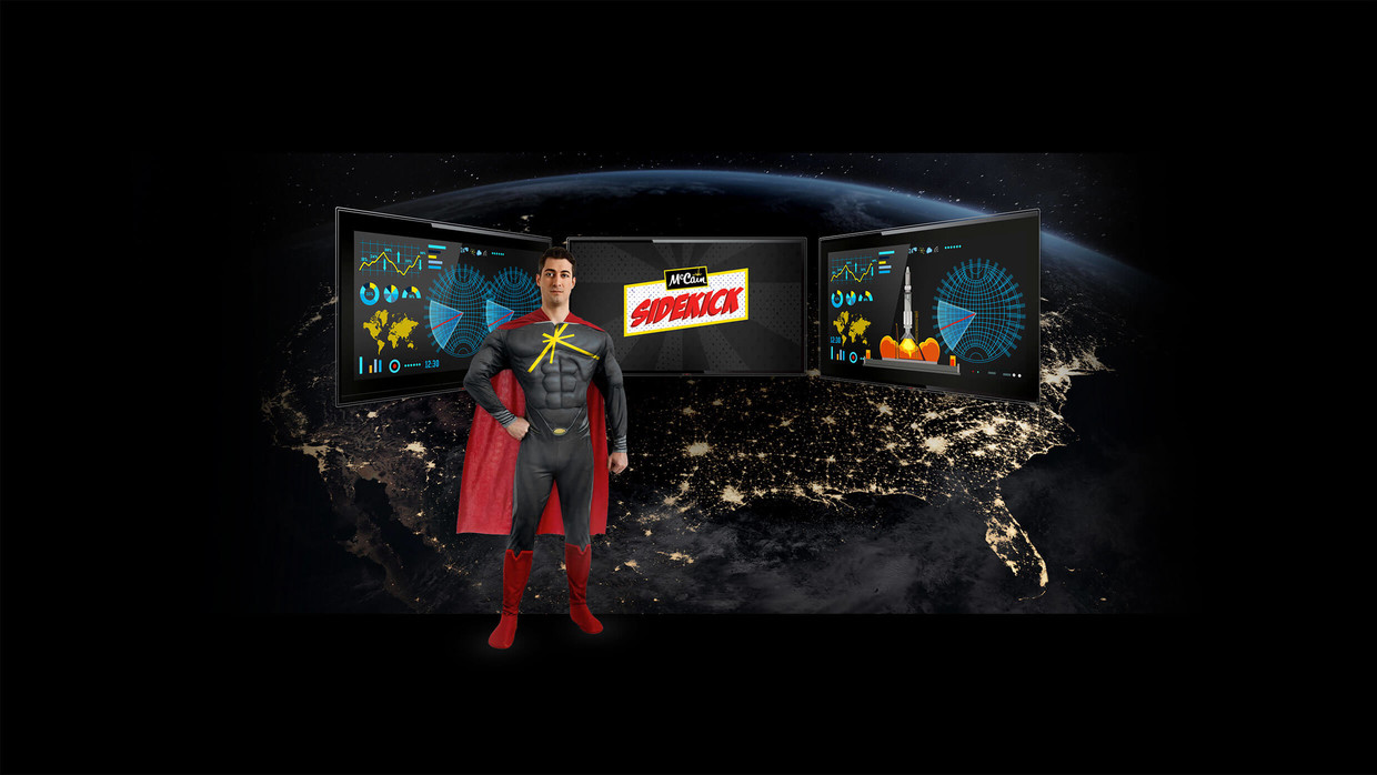 Super hero stands in front of screens