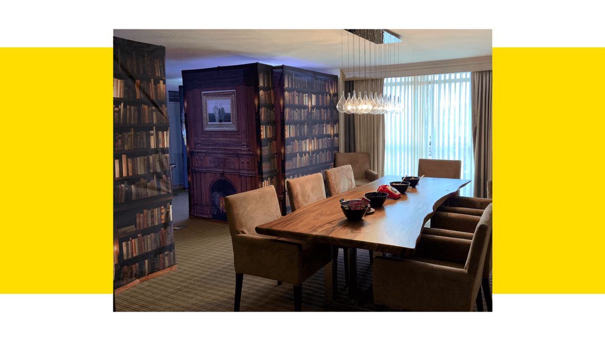 board room table with bookshelves and a secret door